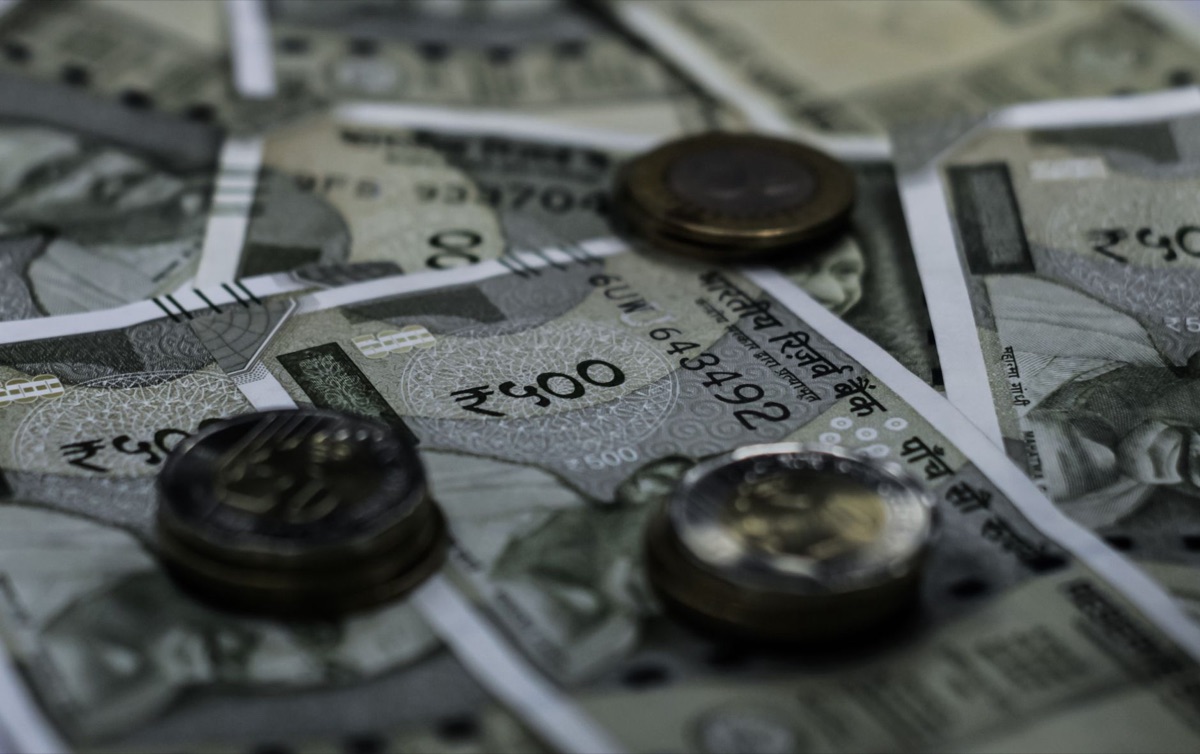 Indian currency and financial growth charts representing economic indicators