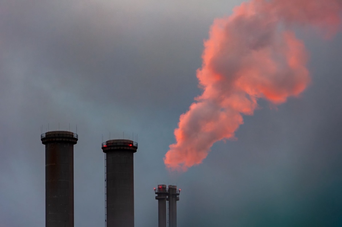 Factory smokestack with visible emissions, industrial setting