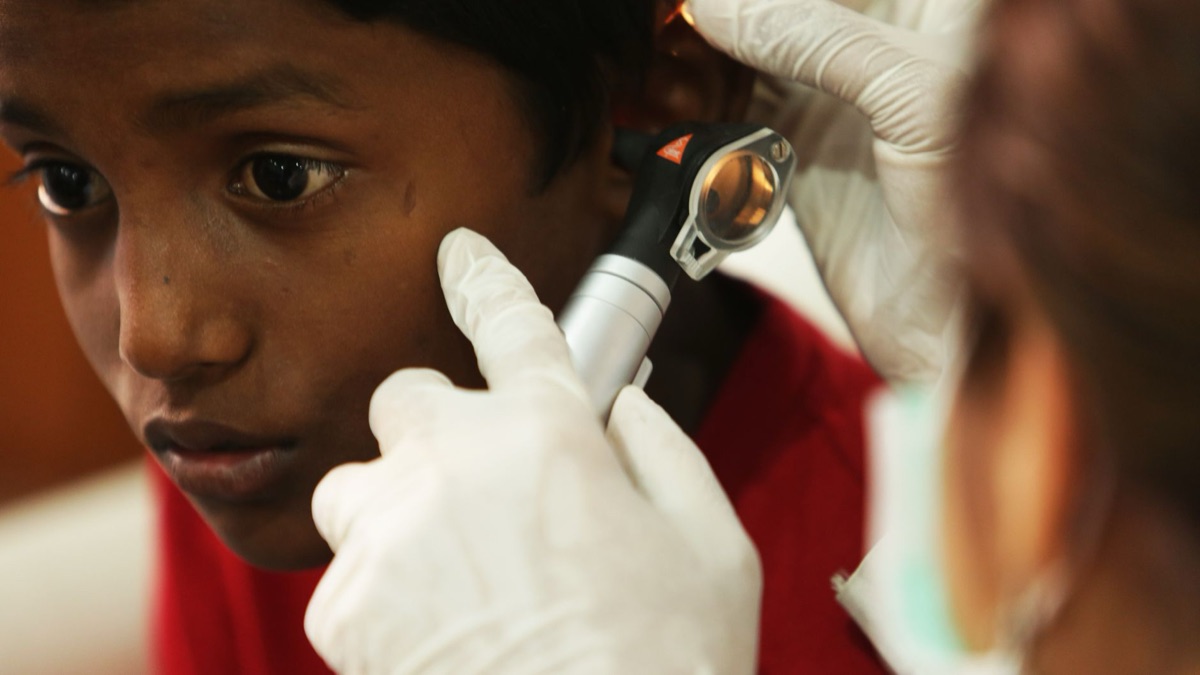 Indian health worker providing care in a rural setting